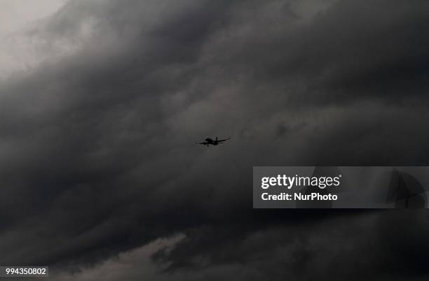 Passenger air craft prepares its landing as monsoon cloud hovering in the sky before the downpour outskirts of the eastern Indian state Odisha's...