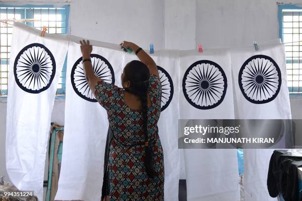 In this photo taken on May 9 Nirmala S. Ilkal hangs the screen printed central strip of the Indian national flag at the Khadi Gramodyog Samyukta...