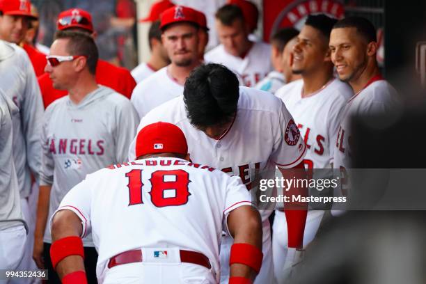 Shohei Ohtani of the Los Angeles Angels of Anaheim celebrates with Luis Valbuena after he hits a solo home run during the MLB game against the Los...