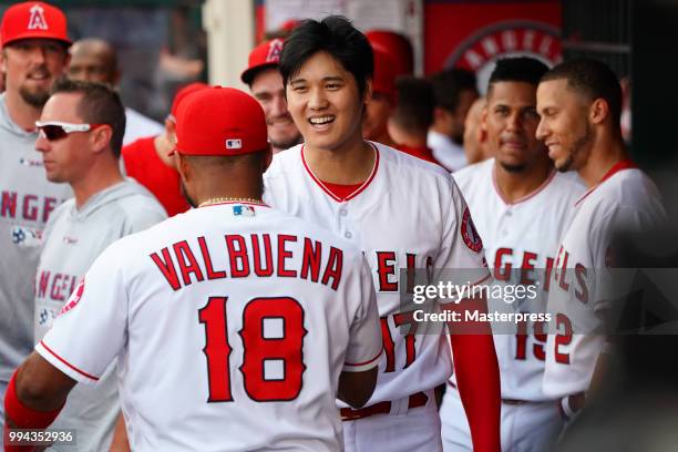 Shohei Ohtani of the Los Angeles Angels of Anaheim celebrates with Luis Valbuena after he hits a solo home run during the MLB game against the Los...