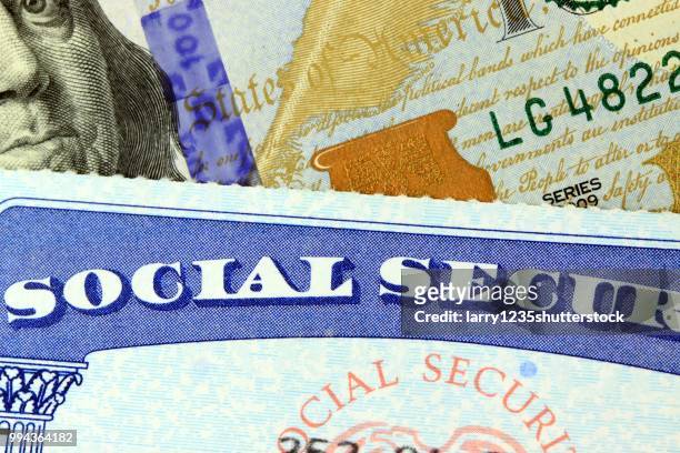 social security card and us currency dollars - social security card foto e immagini stock
