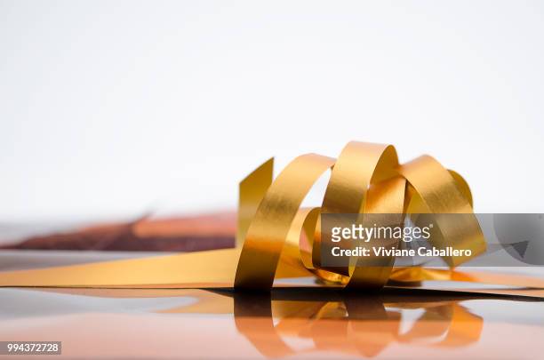 ribbon gold - viviane caballero stock pictures, royalty-free photos & images