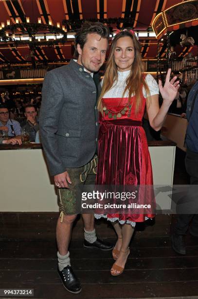Actress Alexandra Kamp and her partner, the photographer and artist Michael von Hassel pose at the Bild Wiesn regulars' table inside the Marstall...