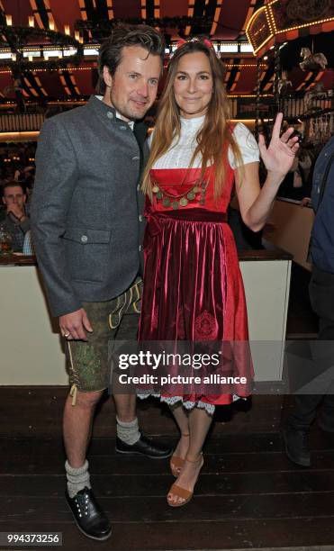 Actress Alexandra Kamp and her partner, the photographer and artist Michael von Hassel pose at the Bild Wiesn regulars' table inside the Marstall...