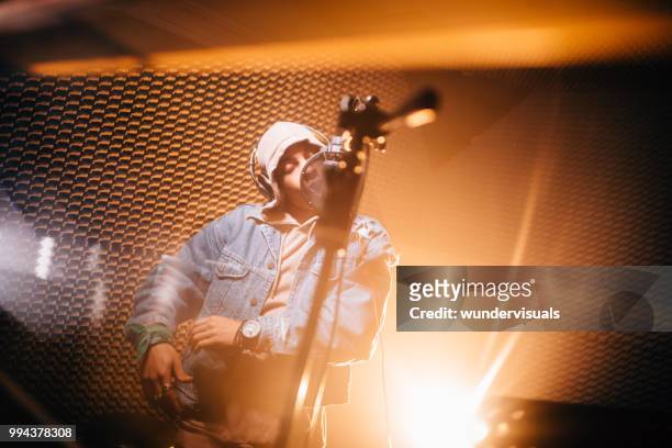 young hipster musician recording songs in professional music studio - rap singer stock pictures, royalty-free photos & images