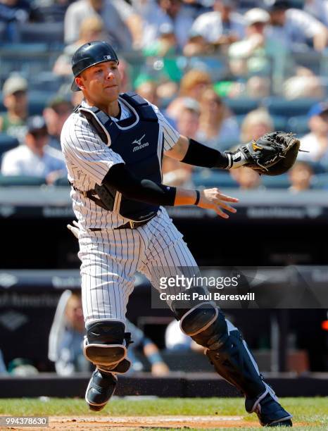 Catcher Austin Romine of the New York Yankees throws to first base during an MLB baseball game against the Seattle Mariners on June 21, 2018 at...