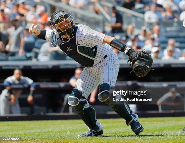 Catcher Austin Romine of the New York Yankees throws to first base during an MLB baseball game against the Seattle Mariners on June 21, 2018 at...