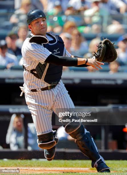 Catcher Austin Romine of the New York Yankees throws to first base during an MLB baseball game against the Seattle Mariners on June 21, 2018 at...