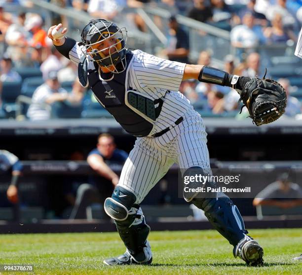 Catcher Austin Romine of the New York Yankees throws to first base during an MLB baseball game against the Seattle Mariners on June 21, 2018 at...