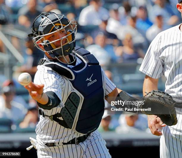 Catcher Austin Romine of the New York Yankees throws to first base during an MLB baseball game against the Seattle Mariners on June 21, 2018 at...