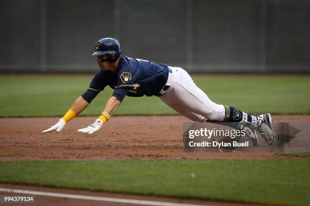 Hernan Perez of the Milwaukee Brewers slides into third base for a triple in the second inning against the Atlanta Braves at Miller Park on July 5,...