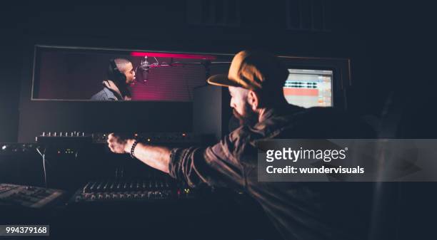 hipster singer and music producer recording songs in music studio - rapper stock pictures, royalty-free photos & images
