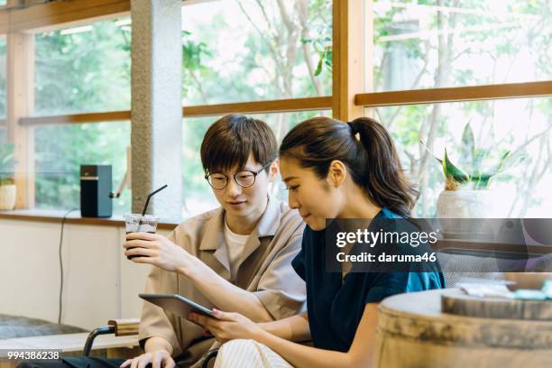 young men and woman discussing at the cafe. - youth coalition stock pictures, royalty-free photos & images