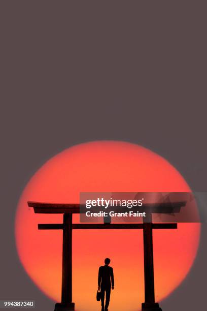 japanese tori gate:composite image. silhouette of businessman. - torii gate stock pictures, royalty-free photos & images