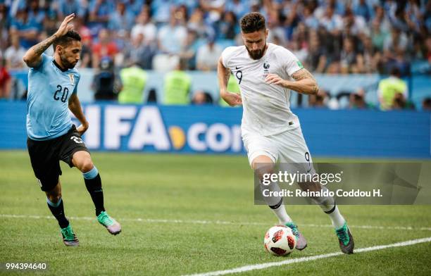Olivier Giroud of France is challenged by Jonathan Urretaviscaya of Uruguay during the 2018 FIFA World Cup Russia Quarter Final match between Winner...