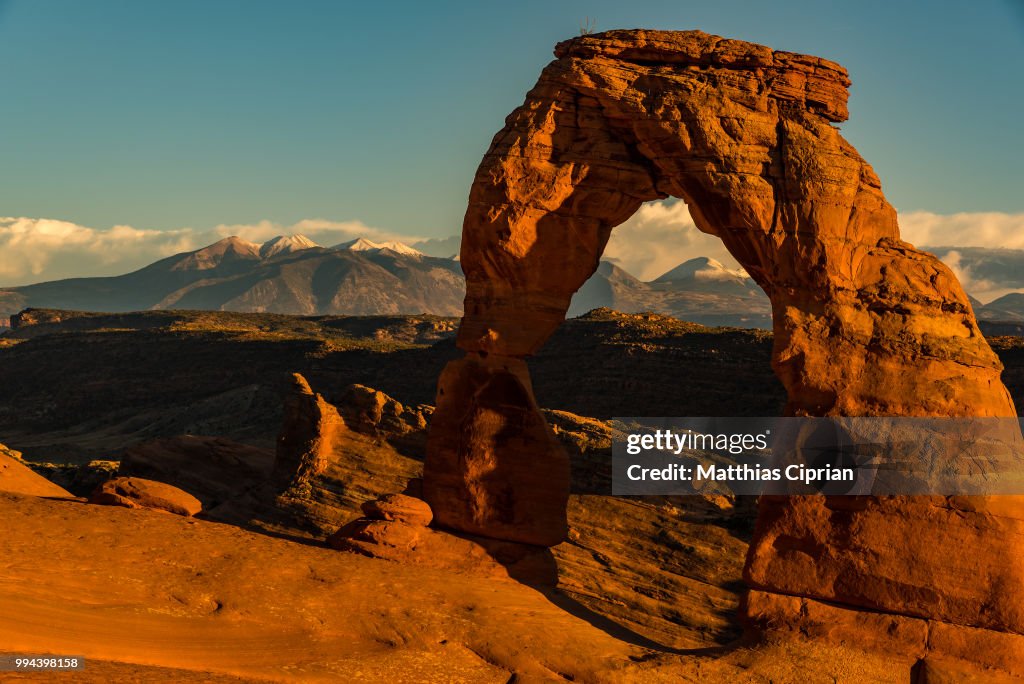 Delicate Arch in front of snowy La Sal Mountains