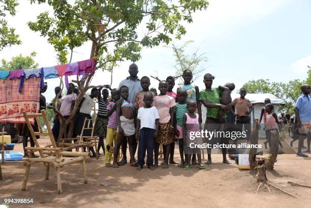 South Sudanese refugee family with five children of their own and five others the have adpoted can be seen at the refugee settlement in Imvepi,...