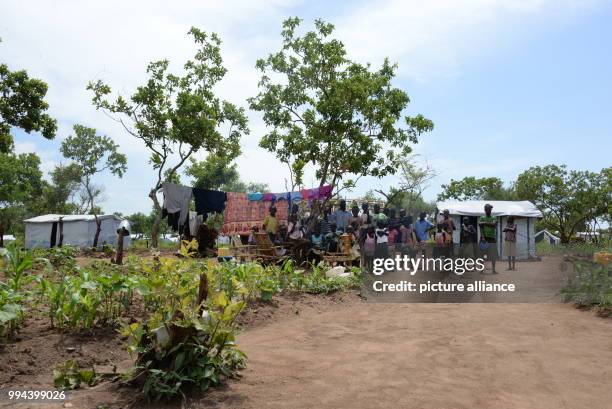 South Sudanese refugee family with five children of their own and five others the have adpoted can be seen at the refugee settlement in Imvepi,...