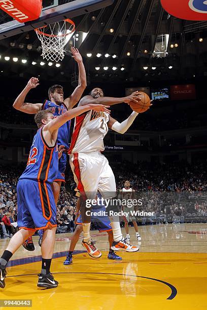 Ronny Turiaf of the Golden State Warriors goes up for a shot against David Lee and Danilo Gallinari of the New York Knicks during the game at Oracle...