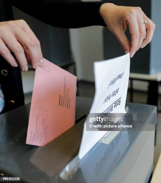 Voters can be seen at the district office Friedrichshain-Kreuzberg for her postal vote for the parliamentary elections, in Berlin, Germany, 19...