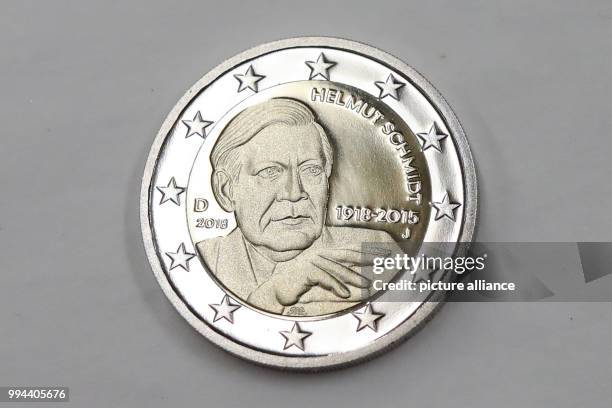 Newly minted 2-Euro-coin with the portrait of the former German Chancellor Helmut Schmidt can be seen on a tray in the mint 'Hamburgischen Muenze' in...