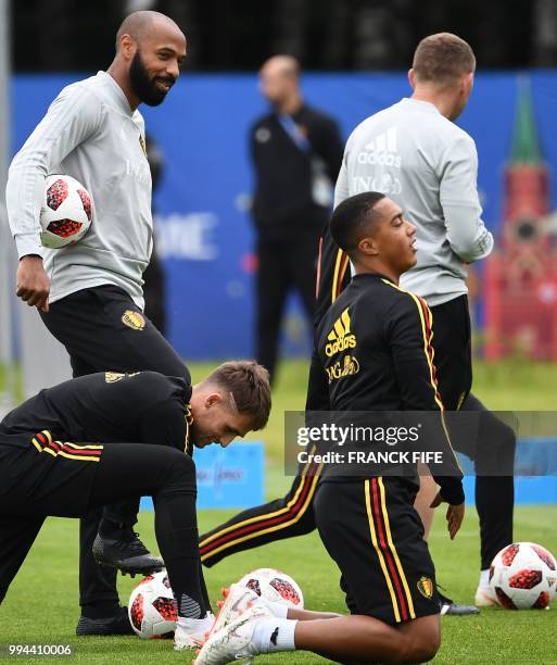 Belgium's assistant coach Thierry Henry speaks with Belgium's midfielder Adnan Januzaj and Belgium's midfielder Youri Tielemans during a training...