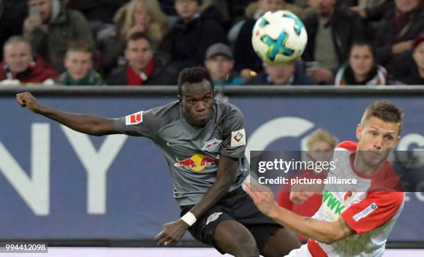 Augsburg's Jeffrey Gouweleeuw and Leipzig's Bruma vie for the ball during the German Bundesliga soccer match between FC Augsburg and RB Leipzig in...