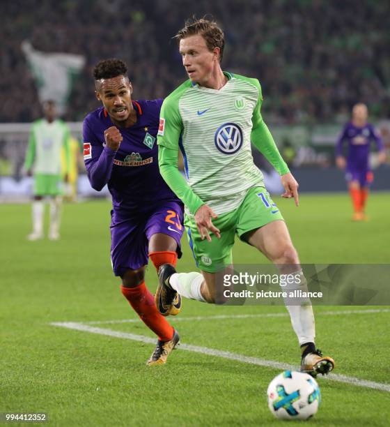 Wolfsburg's Yannick Gerhardt and Werder's Theodor Gebre Selassie vie for the ball during the German Bundesliga soccer match between VfL Wolfsburg and...