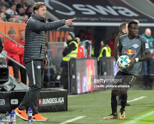 Coach Ralph Hasenhuettl gives instructions to Bruma at a throw-in during the German Bundesliga soccer match between FC Augsburg and RB Leipzig at the...