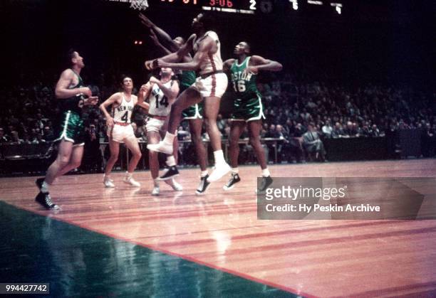 Bill Russell of the Boston Celtics and Willie Naulls of the New York Knicks battle for the rebound during an NBA game on October 25, 1958 at the...