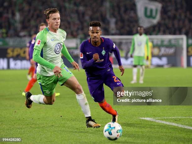 Wolfsburg's Yannick Gerhardt and Werder's Theodor Gebre Selassie vie for the ball during the German Bundesliga soccer match between VfL Wolfsburg and...