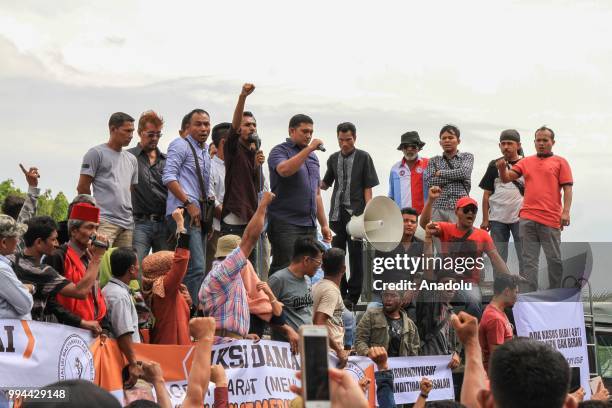Supporters of the Aceh Community Coalition hold a demonstration in front of Baiturrahman Mosque, at Banda Aceh City, Aceh, Indonesia on Monday, July...