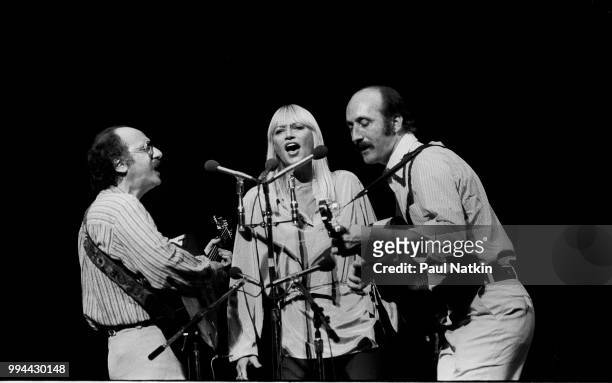 Folk group Peter, Paul, & Mary, left to right, Peter Yarrow, Mary Travers and Noel Paul Stookey, perform on stage at the Auditorium Theater in...