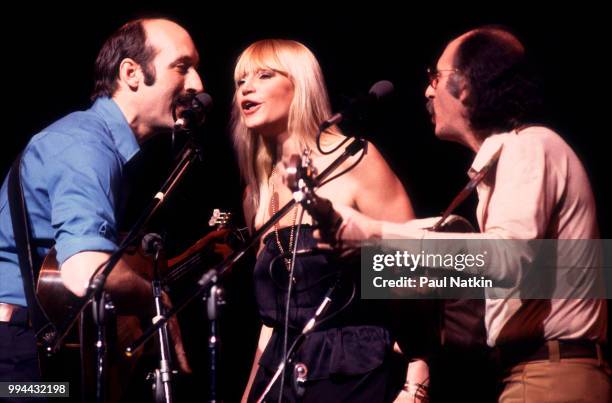 Folk group Peter, Paul, & Mary, left to right, Peter Yarrow, Mary Travers and Noel Paul Stookey, perform on stage at the Poplar Creek Music Theater...