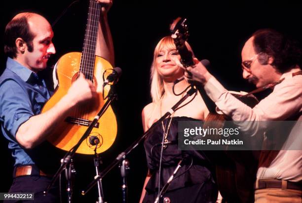 Folk group Peter, Paul, & Mary, left to right, Peter Yarrow, Mary Travers and Noel Paul Stookey, perform on stage at the Poplar Creek Music Theater...