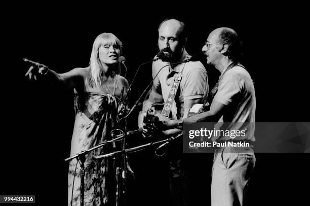 Folk group Peter, Paul, & Mary, left to right, Mary Travers, Peter Yarrow, and Noel Paul Stookey, perform on stage at the Poplar Creek Music Theater...