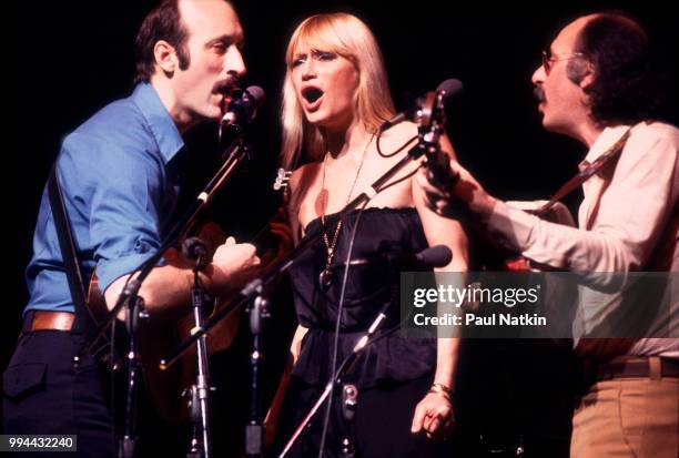 Folk group Peter, Paul, & Mary, left to right, Peter Yarrow, Mary Travers and Noel Paul Stookey, perform on stage at the Poplar Creek Music Theater...