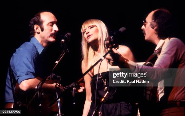 Folk group Peter, Paul, & Mary, left to right, Peter Yarrow, Mary Travers and Noel Paul Stookey, perform on stage at the Poplar Creek Music Theater...