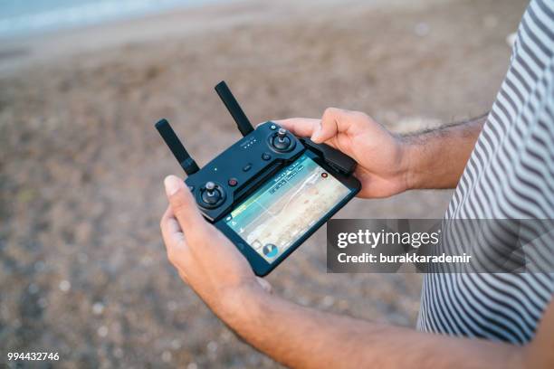 man pilot calibrating drone - beard pilot stock pictures, royalty-free photos & images