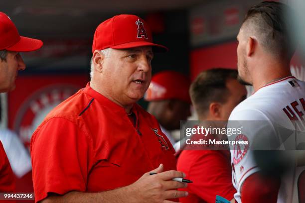 Manager Mike Scioscia talks with Andrew Heaney of the Los Angeles Angels of Anaheim during the MLB game against the Los Angeles Dodgers at Angel...