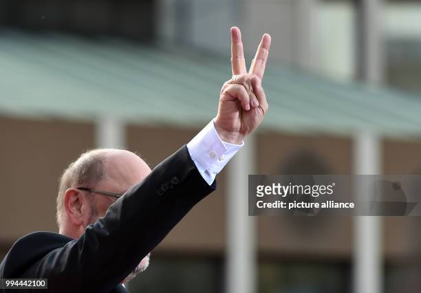 Germany's Social Democratic Party's top candidate Martin Schulz shows the victory sign during a campaign event of the SPD North Rhine-Westphalia in...