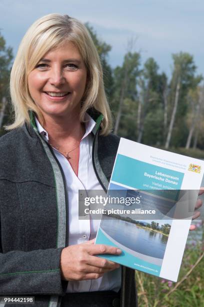 The Bavarian Minister for the Environment Ulrike Scharf stands on an obervation tower in the region of the mouth of the river Isar near the Danube in...