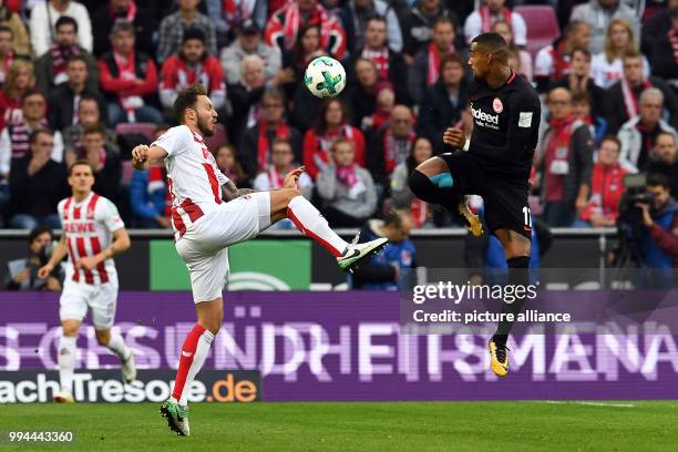 Cologne's Marco Hoeger and Frankfurt's Kevin-Prince Boateng vie for the ball during the German Bundesliga soccer match between 1. FC Cologne and...