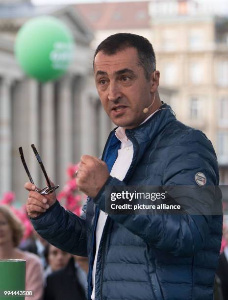 The party chairman of Germany's Buendnis 90/Die Gruenen , Cem Oezdemir speaks during a campaign event on the Schlossplatz square in Stuttgart,...