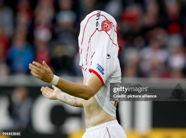 Duesseldorf's Benito Raman pulls his shirt over his face after a missed chance during the German Second Bundesliga soccer match between Fortuna...