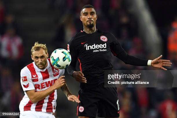 Cologne's Marcel Risse and Frankfurt's Kevin-Prince Boateng vie for the ball during the German Bundesliga soccer match between 1. FC Cologne and...