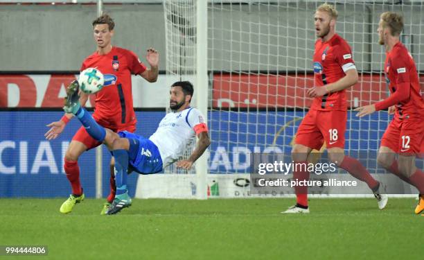 Heidenheim's Kolja Pusch stands next to Darmstadt's Aytac Sulu during the German Second Bundesliga soccer match between 1. FC Heidenheim and...