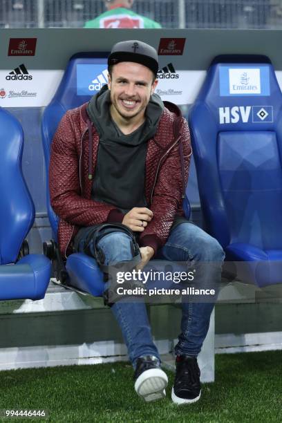 Hamburg's injured forward Nicolai Mueller sits on the bench during the German Bundesliga soccer match between Hamburger SV and Borussia Dortmund in...