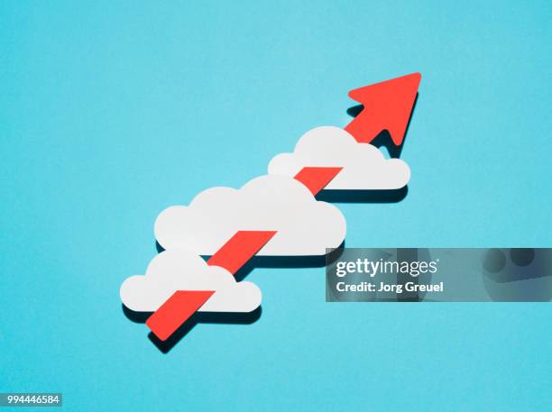 paper clouds pierced by an arrow - jorg greuel stock pictures, royalty-free photos & images