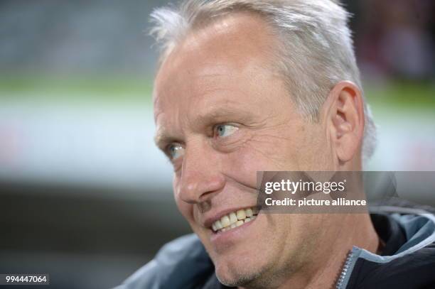 Freiburg's coach Christian Streich watches the warming up of his team prior to the German Bundesliga soccer match between SC Freiburg and Hannover 96...